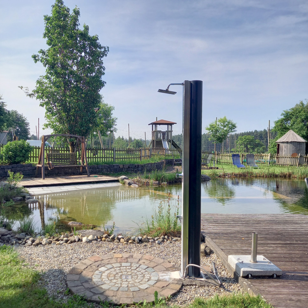Pitch on a holiday farm with natural pool
